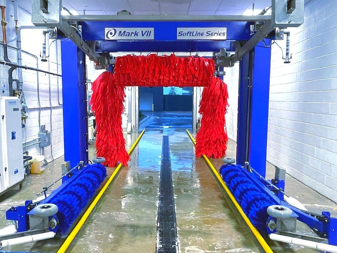 Mark VII SoftLine drive thru tunnel with red rollers on both side and above and blue wheel cleaners before those.