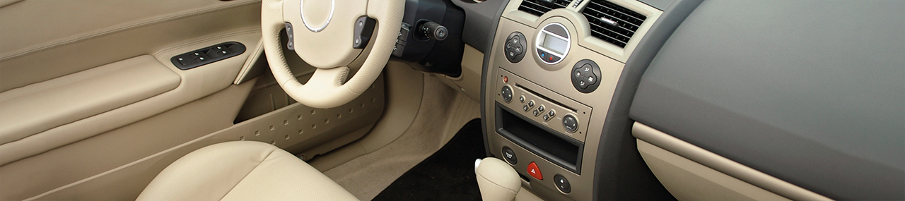 The inside of a car with tan interior.