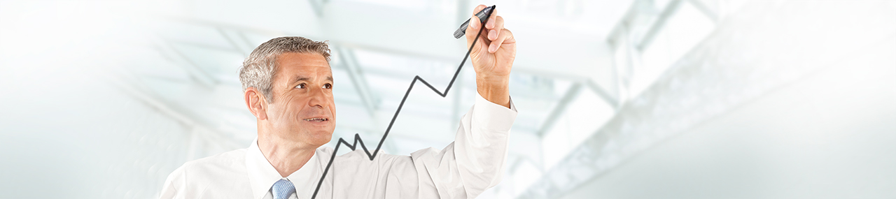 Man smiling wearing a white suit drawing an arrow representing revenue pointing up.