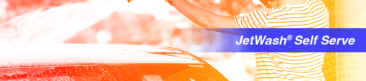 Man washing car with a JetWash self service car wash on a sunny summer day.